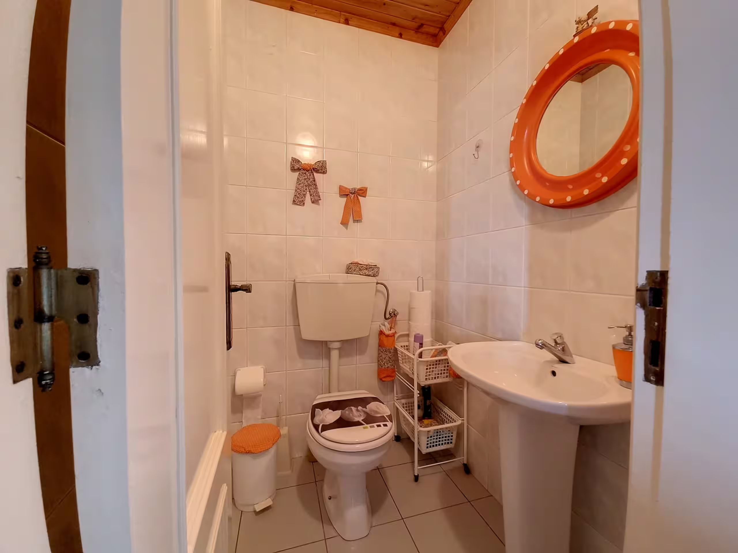 Bathroom 3, off the upstairs lounge, with basin and toilet under the beamed ceiling