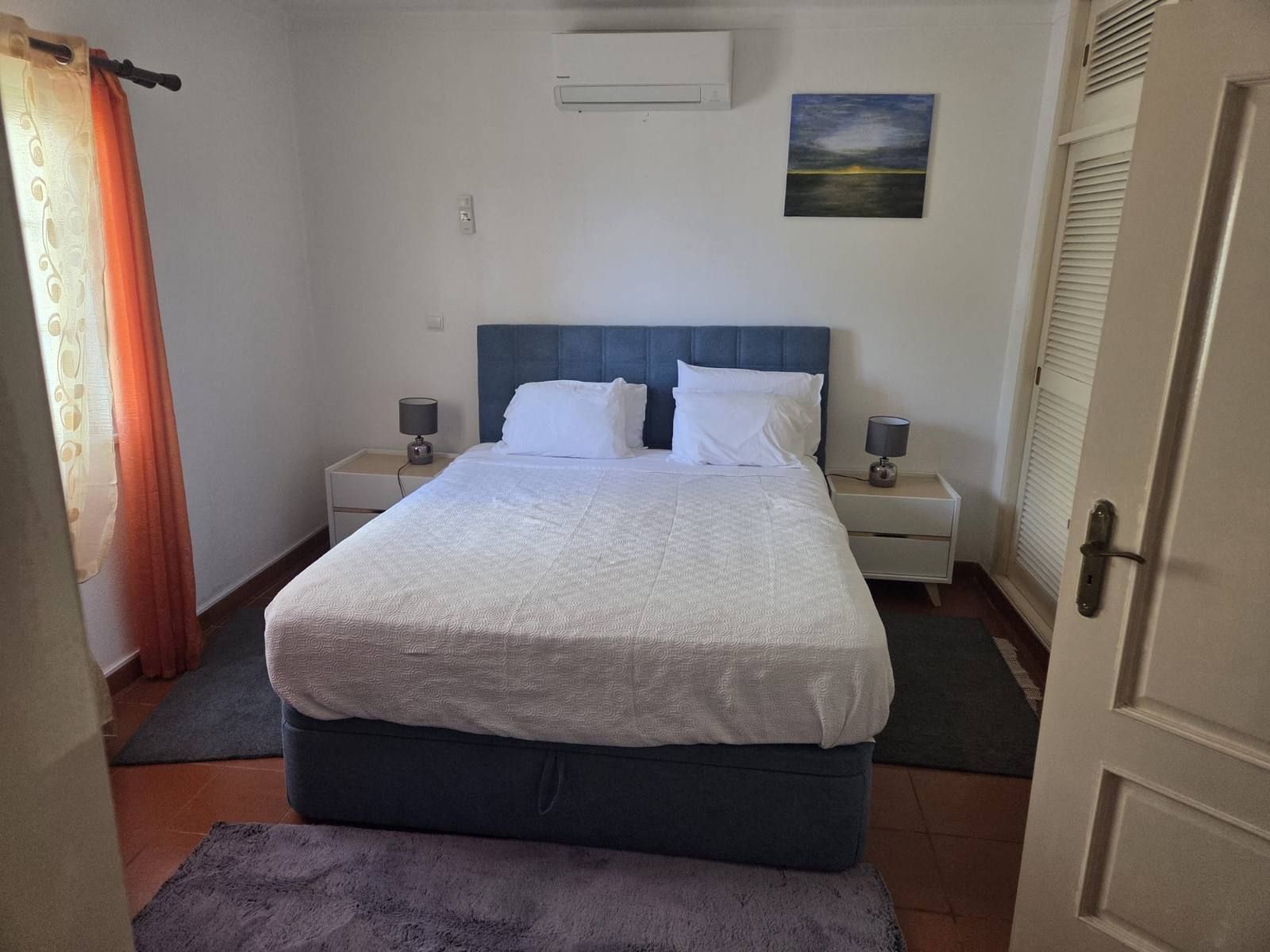Bedroom 1, queen bed with bedside lamps