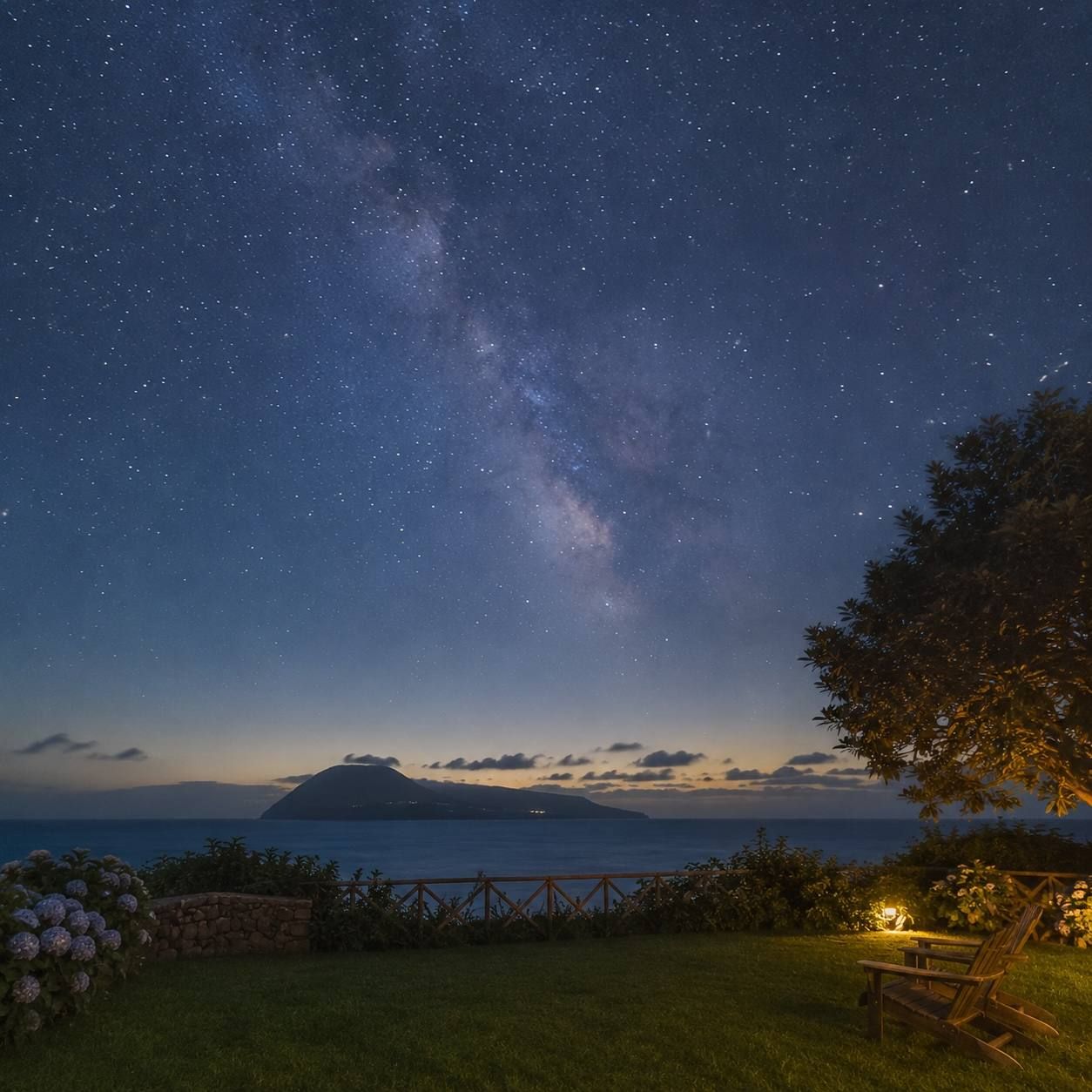 The Milky Way over the garden and the sea at night